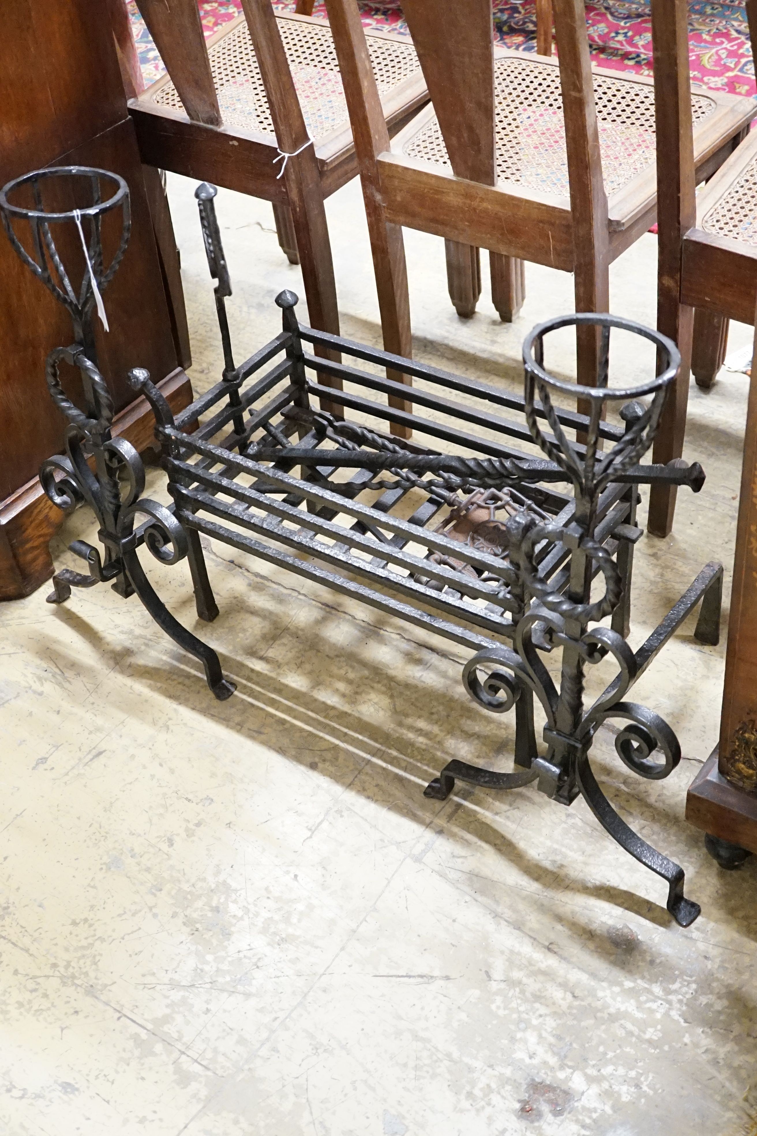 A group of wrought iron fireside effects including a pair of dogs, basket, 54 cm wide etc.